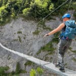 Man walking over suspended bridge at Murren via ferrata