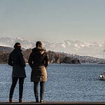 People standing at the shore of lake Zurich