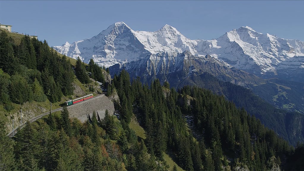 Aerial view of the schynige platte railway with eiger, mönch and jungfrau peaks in the background